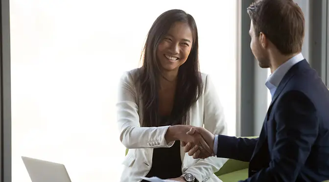 Businessman handshake smiling Asian client closing business deal