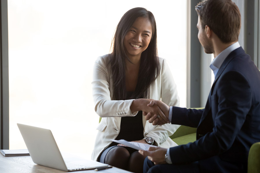 Businessman handshake smiling Asian client closing business deal