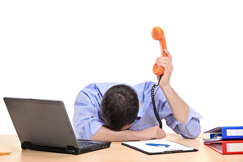 Exhausted Businessman Holding phone