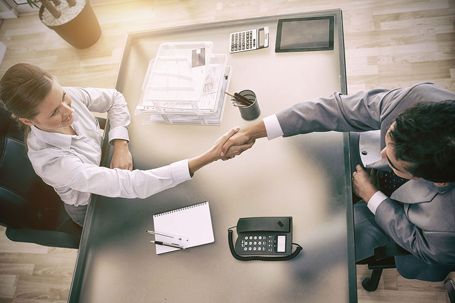 Above view of a sales consultant shaking hands