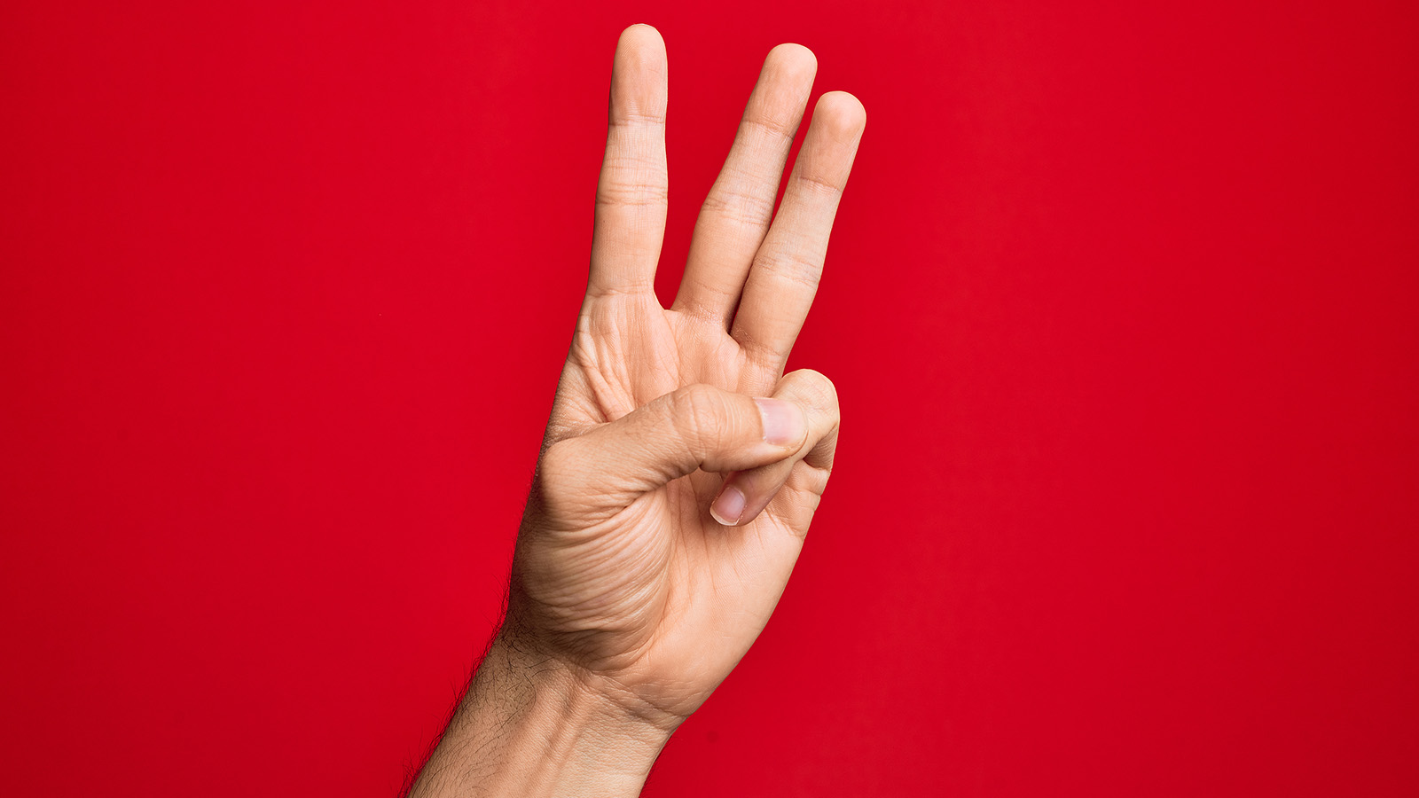 showing three fingers