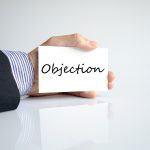 Businessman holding objection card