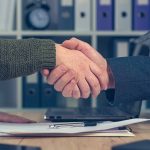 Business man and woman shaking hands