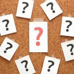 Questions marks pinned to cork board