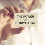 Businessman holding card saying the power of storytelling