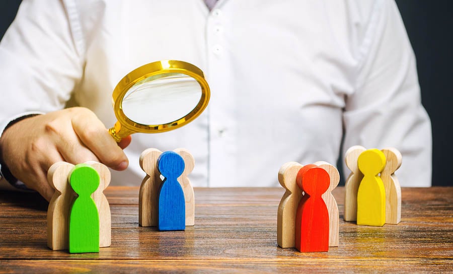 Groups of multicolored wooden people and businessman