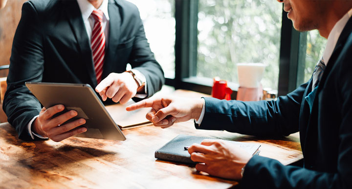 Business conversation discussing a concept on a tablet
