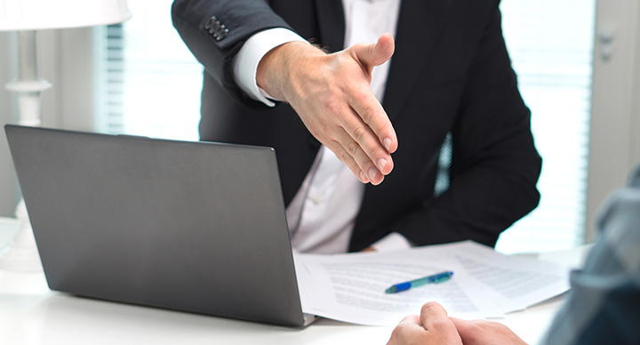 Sales person shaking hands after arranging a deal