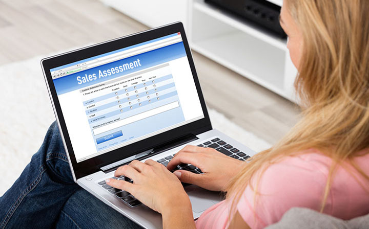 High Angle View Of A Woman Giving Online Survey On Laptop At Home