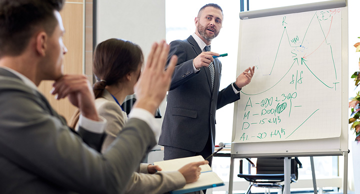 Sales person standing at a flipchart giving a presentation