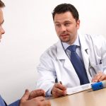 Two men discussing doctor and patient - visit in the office