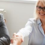 Smiling Attractive Mature Businesswoman Handshaking Businessman