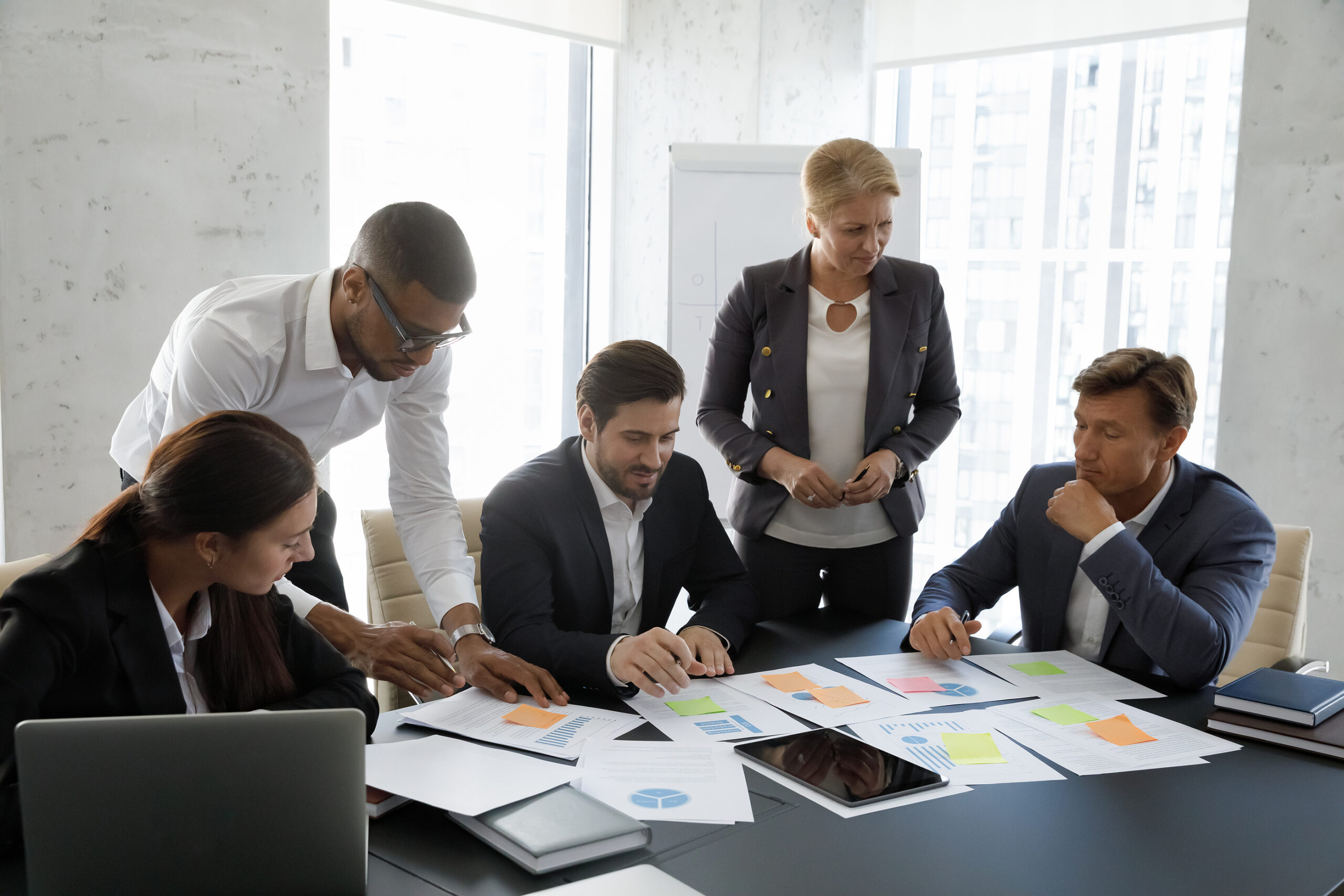 Sales-team-gathered-in-boardroom